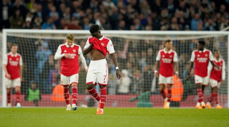 Arsenal's Bukayo Saka, center, reacts after Manchester City's scored their third goal during the English Premier League soccer match between Manchester City and Arsenal at Etihad stadium in Manchester, England, Wednesday, April 26, 2023. (AP Photo/Dave Thompson)