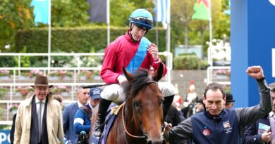 Richard Kingcote is led back into the winner's enclosure after victory in the Qipco Champion Stakes on Bay Bridge