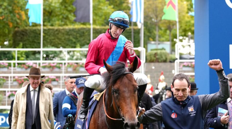 Richard Kingcote is led back into the winner's enclosure after victory in the Qipco Champion Stakes on Bay Bridge