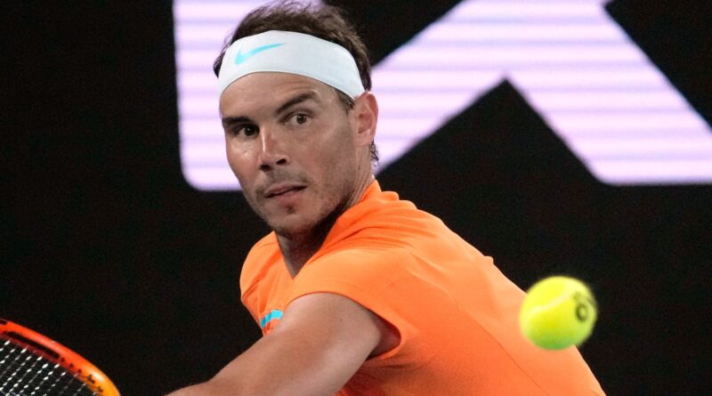 Rafael Nadal of Spain plays a backhand return to Mackenzie McDonald of the U.S. during their second round match at the Australian Open tennis championship in Melbourne, Australia, Wednesday, Jan. 18, 2023. (AP Photo/Dita Alangkara)