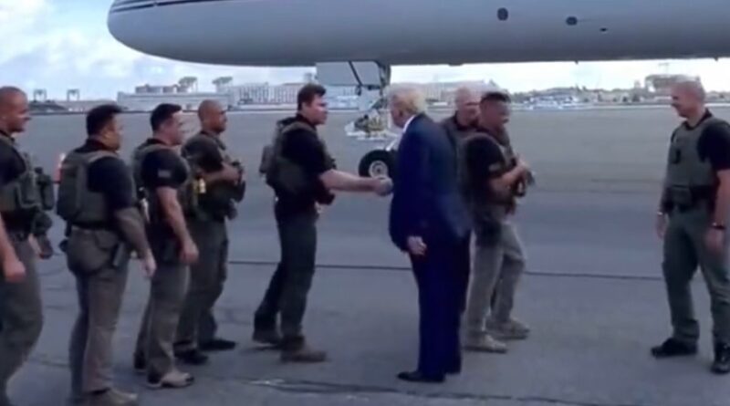 Trump is greeted by law enforcement as he arrives in Massachusetts.