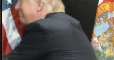 Trump hugs American flag