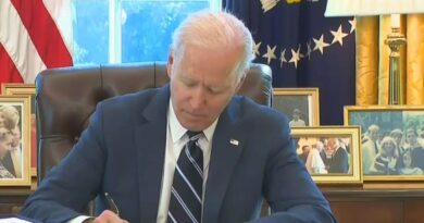 Joe Biden signs the stimulus bill.