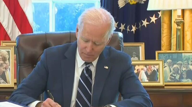 Joe Biden signs the stimulus bill.