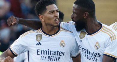 Real Madrid's Jude Bellingham, left, celebrates with Real Madrid's Antonio Rudiger, centre, after scoring his side's opening goal during the La Liga soccer match between Barcelona and Real Madrid at the Olympic Stadium in Barcelona, Spain, Saturday, Oct. 28, 2023. (AP Photo/Joan Monfort)