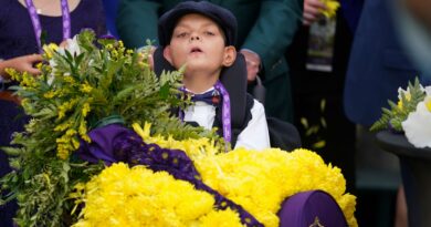 Cody Dorman wears the winner's flower sash after Cody's Wish's success in the Breeders' Cup Dirt Mile