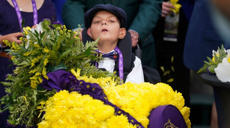 Cody Dorman wears the winner's flower sash after Cody's Wish's success in the Breeders' Cup Dirt Mile