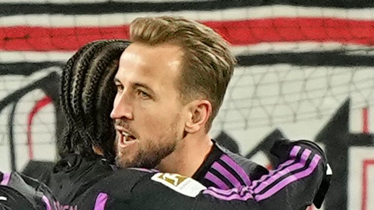 Bayern's Harry Kane, right, celebrates with his teammates after scoring his side's opening goal during the German Bundesliga soccer match between 1.FC Cologne and Bayern Munich in Cologne, Germany, Friday, Nov. 24, 2023. (AP Photo/Martin Meissner)