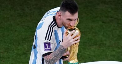 Lionel Messi kisses the World Cup trophy after Argentina's win on penalties against France