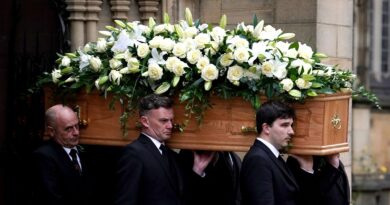 The coffin of Sir Bobby Charlton is carried by pallbearers out of Manchester Cathedral after the funeral service