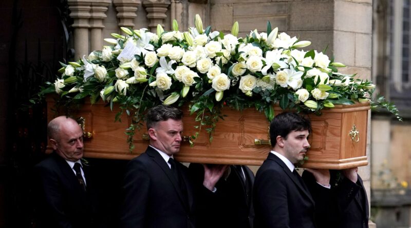 The coffin of Sir Bobby Charlton is carried by pallbearers out of Manchester Cathedral after the funeral service