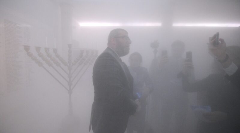 Far-right Polish politician puts out menorah with fire extinguisher