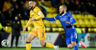 Livingston's Michael Devlin (L) and St Johnstone's Stevie May in action