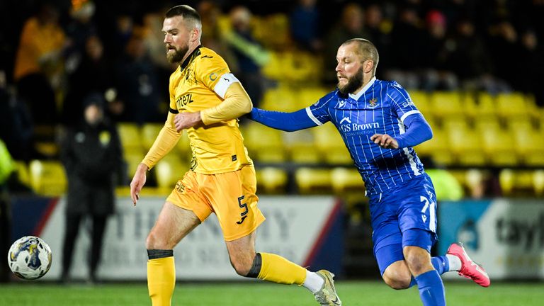 Livingston's Michael Devlin (L) and St Johnstone's Stevie May in action