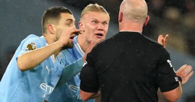 Manchester City players react after referee Simon Hooper stops play after initially allowing the game to continue following a challenge on Erling Haaland