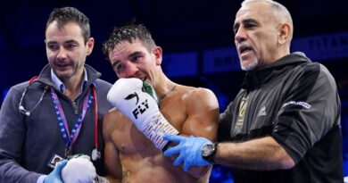 Michael Conlan is helped to his corner by medical staff and a coach after the Referee stops the fight, leading to victory for Jordan Gill after defeating Michael Conlan, during the WBA International Super Featherweight Title fight