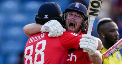 England's batsmen Harry Brook, left, and Phil Salt..celebrate defeating West Indies' by seven wickets with one ball remaining during the third T20 cricket match at National Cricket Stadium in Saint George's, Grenada, Saturday, Dec. 16, 2023. (AP Photo/Ricardo Mazalan)