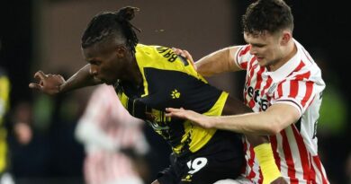 Vakoun Issouf Bayo of Watford and Luke McNally of Stoke City battle for the ball