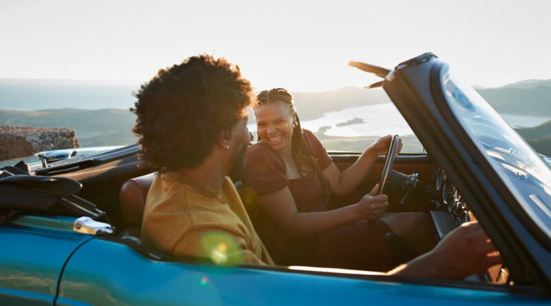 Woman driving by boyfriend sitting in car