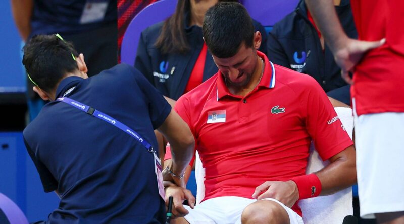 Novak Djokovic receives treatment on a wrist injury