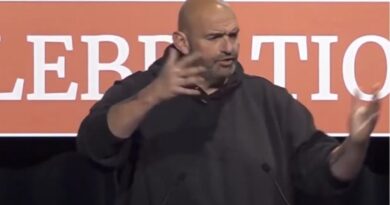 John Fetterman gives a speech in Iowa.