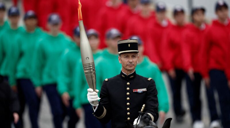 Olympic flame arrives in Paris, at the center of Bastille Day parade